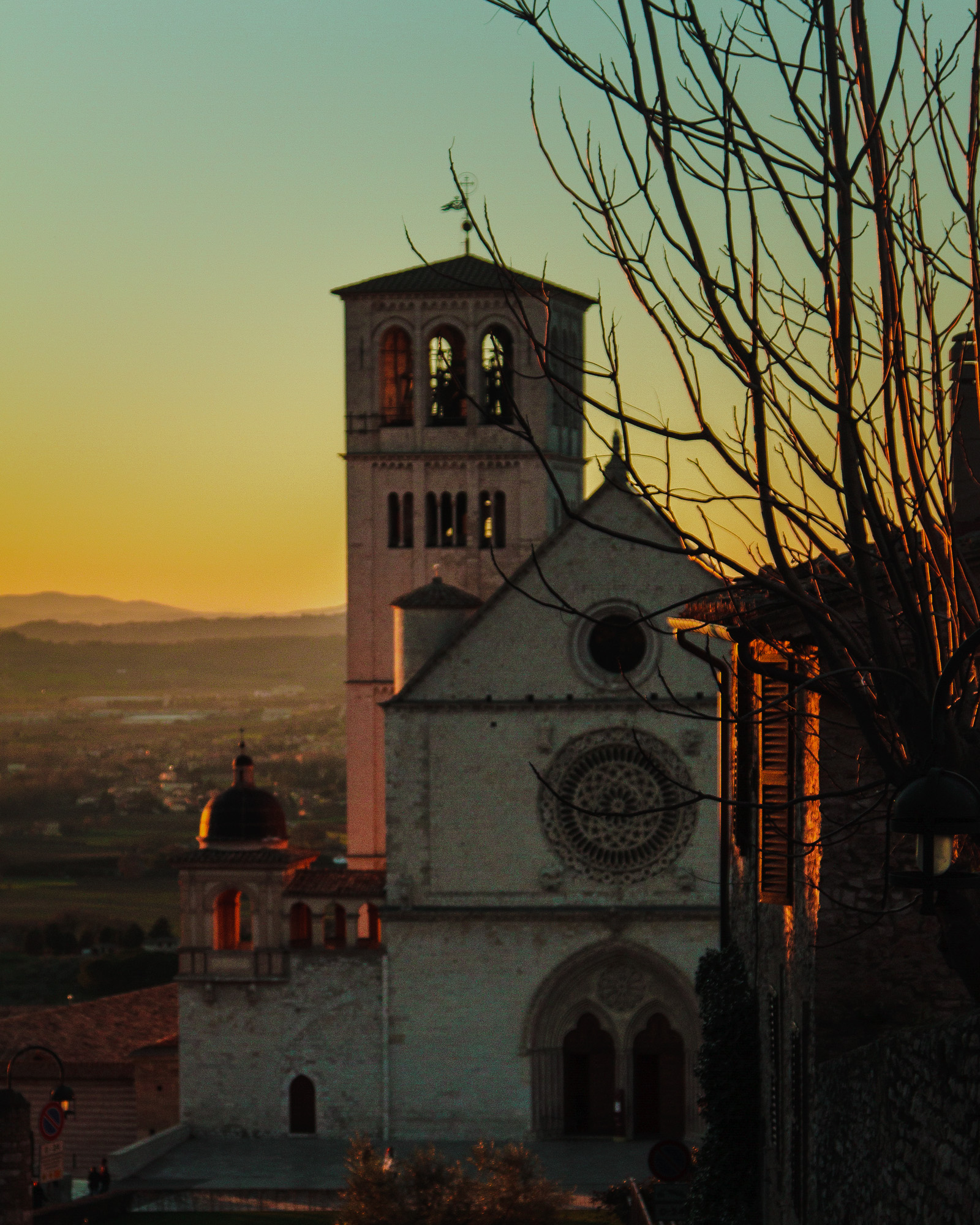 Basilica on a hillside above a wide valley at sunset — street photograph by Hamudi Leon