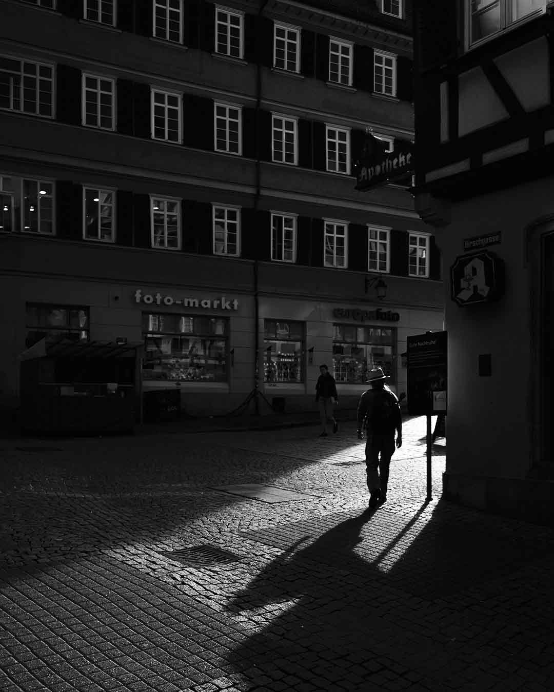 Street photograph in Tübingen in Germany, at down, people in the old city