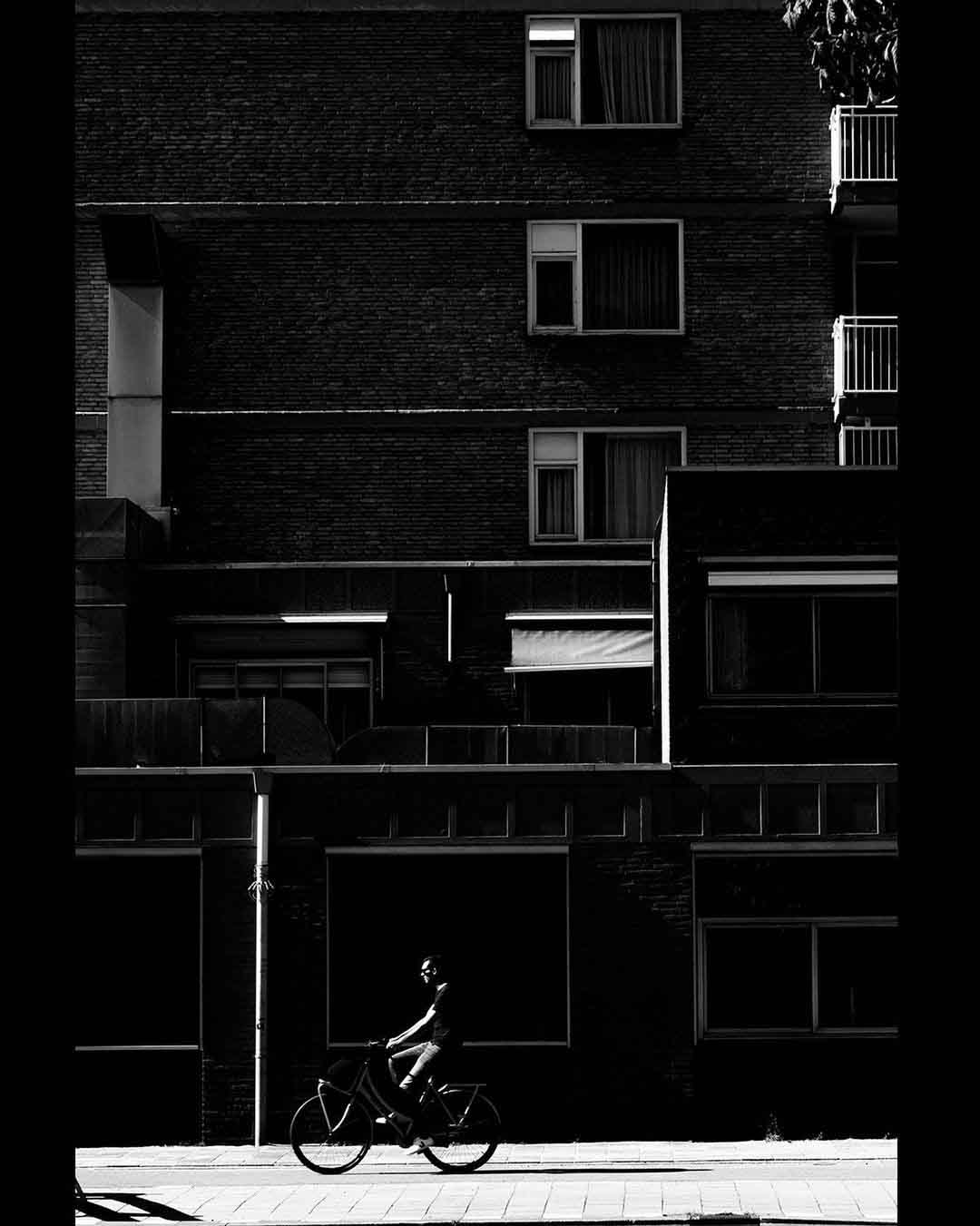 Street Photographs made in Amsterdam highlighting contrast of architecture , lines and people. Black and white